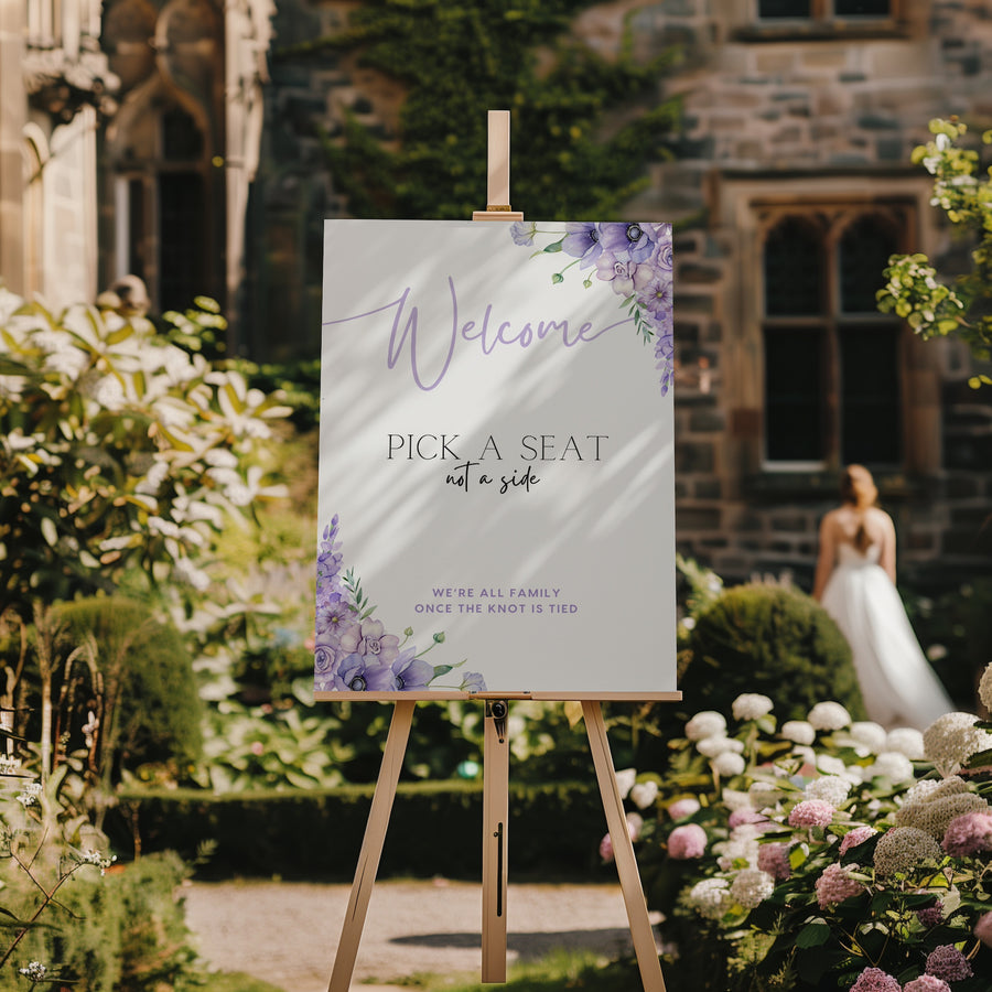 lilac lavender floral wedding pick a seat not a side sign - wedding ceremony sign, with a crisp white background and pretty lilac flowers, alongside elegant text