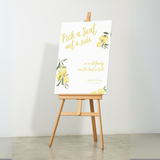 Limoncello pick a seat not a side wedding sign with lemon watercolour illustrations and yellow script text