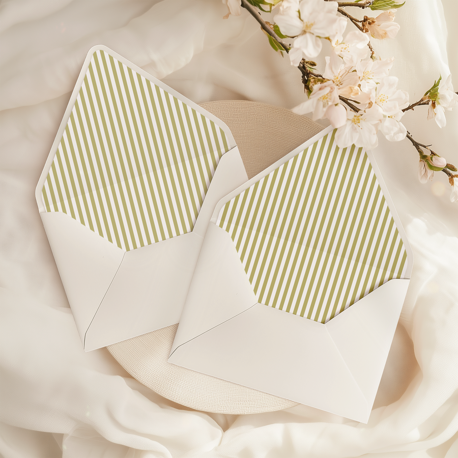A flat lay of elegant wedding invitation envelopes, partially open to reveal beautifully designed envelope liners in various styles, including floral, modern, and classic patterns. The envelope inserts add a touch of luxury and sophistication to the stationery set.