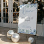 blue floral pick a seat not a side wedding ceremony sign - a personalised "pick  seat, not a side" wedding welcome sign, with a crisp white background and elegant dusty blue text, adorned with soft blue floral blooms