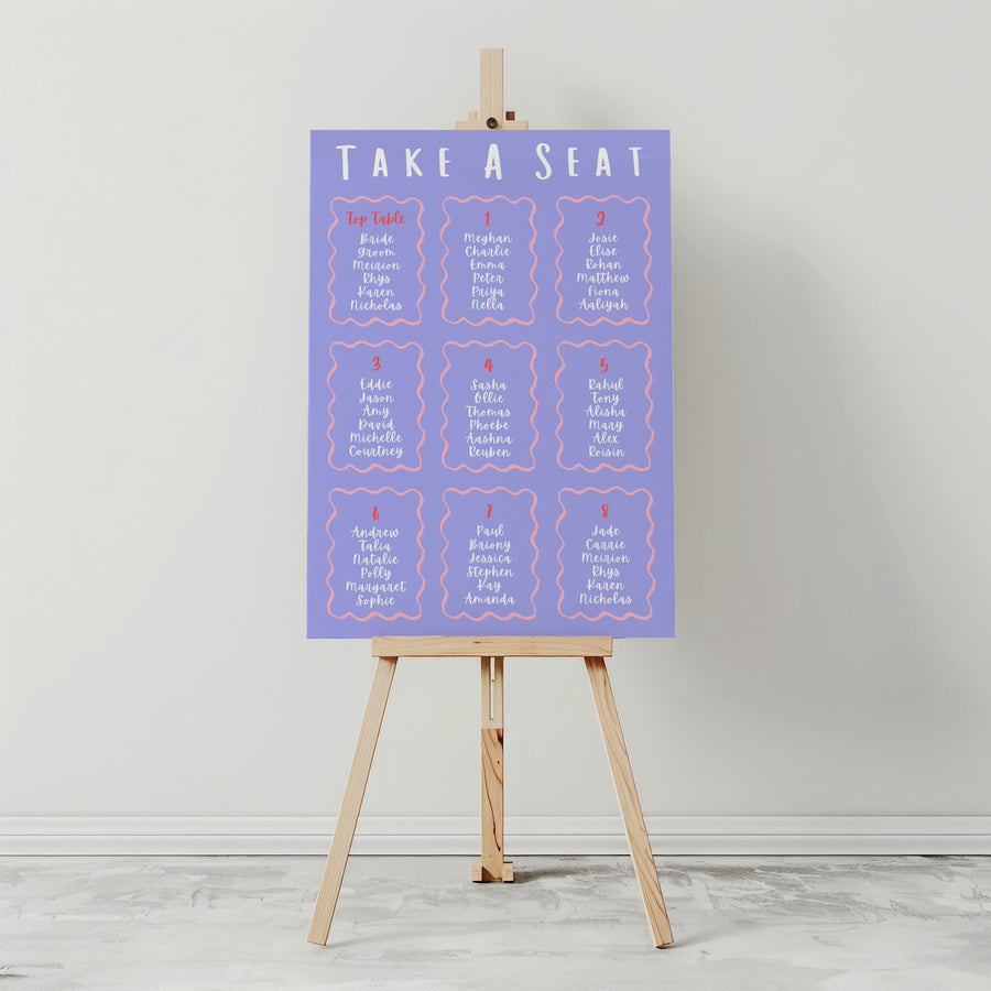 Purple seating chart on a wooden easel against a gray background