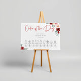 romantic red floral order of the day wedding sign - a crisp white background, with elegant black text and soft, romantic red blooms.