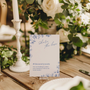 Santorini social media hashtag wedding sign with blue botanical sketches and elegant handwritten script