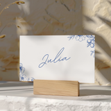 Santorini wedding place card with blue botanical sketches and elegant handwritten script