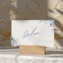 Santorini wedding place card with blue botanical sketches and elegant handwritten script