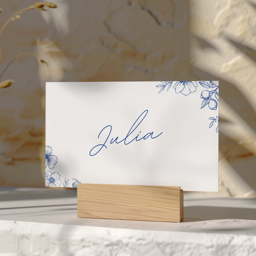 Santorini wedding place card with blue botanical sketches and elegant handwritten script