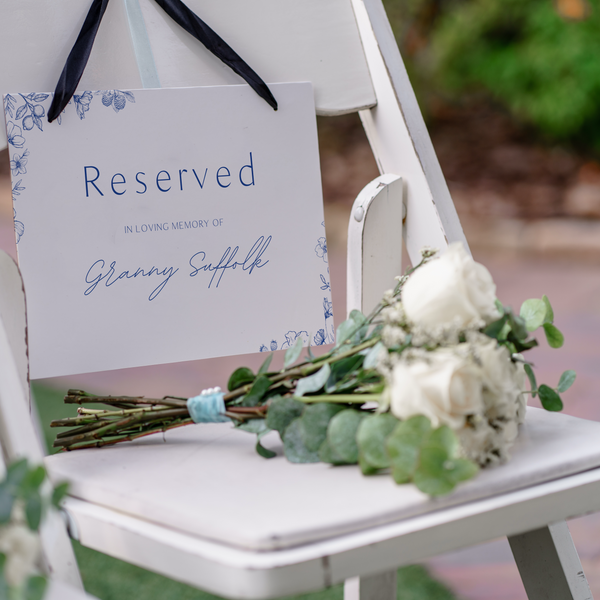 Santorini reserved in memory wedding chair sign with blue botanical sketches and elegant handwritten script