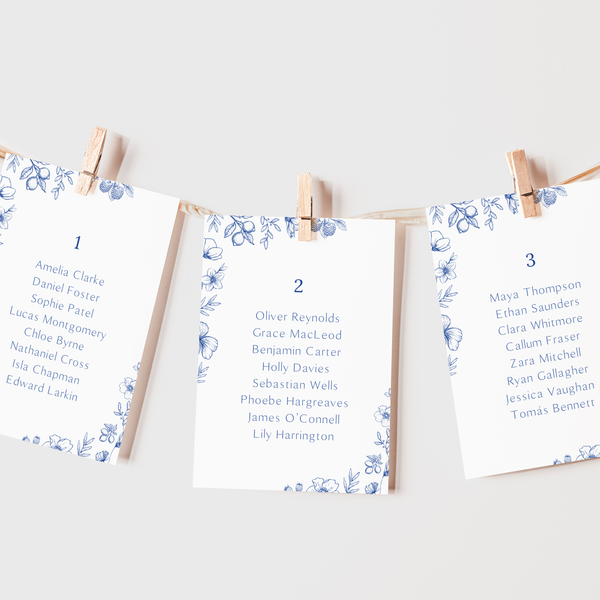 Santorini wedding seating plan cards with blue botanical sketches and elegant handwritten script