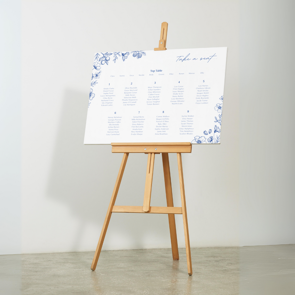 Santorini wedding seating plan sign with blue botanical sketches and elegant handwritten script