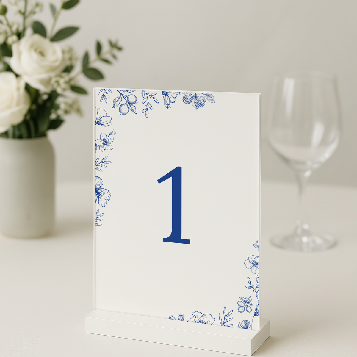 Santorini wedding table number card with blue botanical sketches and elegant handwritten script