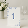 Santorini wedding table number card with blue botanical sketches and elegant handwritten script