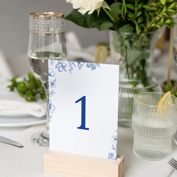 Santorini wedding table number card with blue botanical sketches and elegant handwritten script