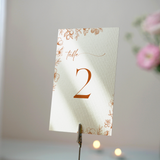 Sienna floral wedding table number card with terracotta botanical sketches and elegant boho typography