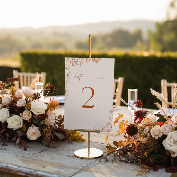 Sienna floral wedding table number card with terracotta botanical sketches and elegant boho typography