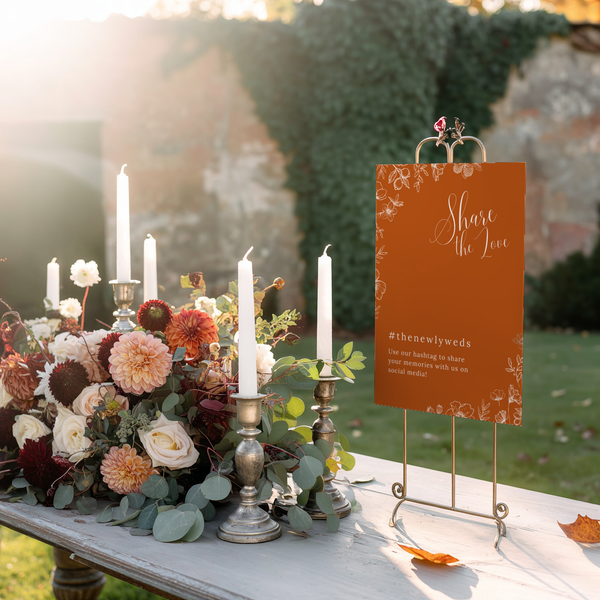 Toasted Amber social media hashtag wedding sign with burnt orange background and white botanical line art