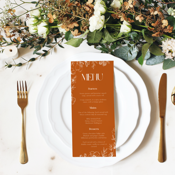 Toasted Amber wedding table number card with burnt orange background and white botanical line art