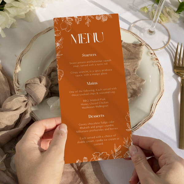 Toasted Amber wedding table number card with burnt orange background and white botanical line art