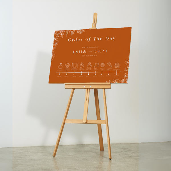 Toasted Amber wedding order of the day sign with burnt orange background and white botanical line art
