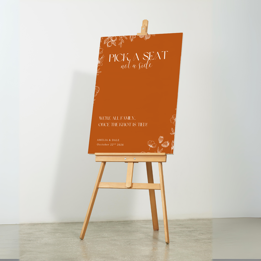 Toasted Amber pick a seat not a side wedding sign with burnt orange background and white botanical line art