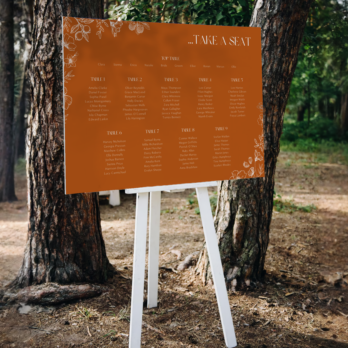Toasted Amber wedding seating plan sign with burnt orange background and white botanical line art