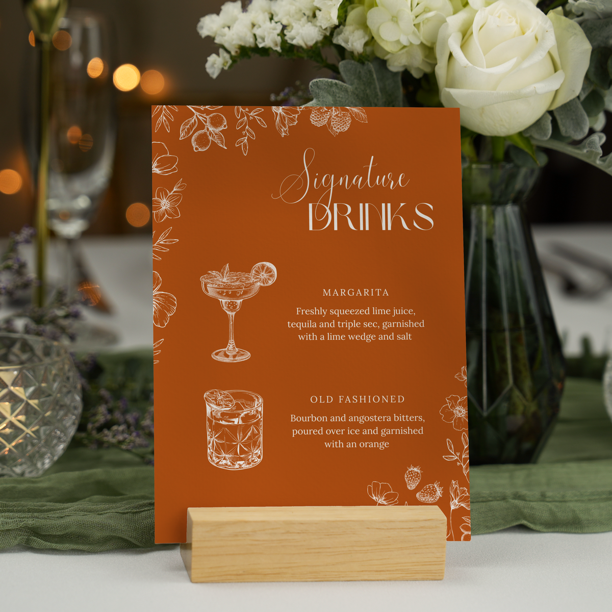 Toasted Amber signature drinks wedding sign with burnt orange background and white botanical line art