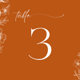 Toasted Amber wedding table number card with burnt orange background and white botanical line art