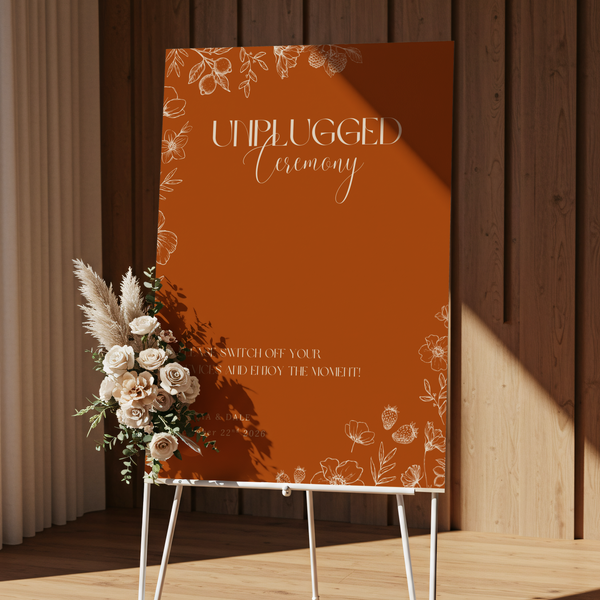 Toasted Amber unplugged ceremony wedding sign with burnt orange background and white botanical line art