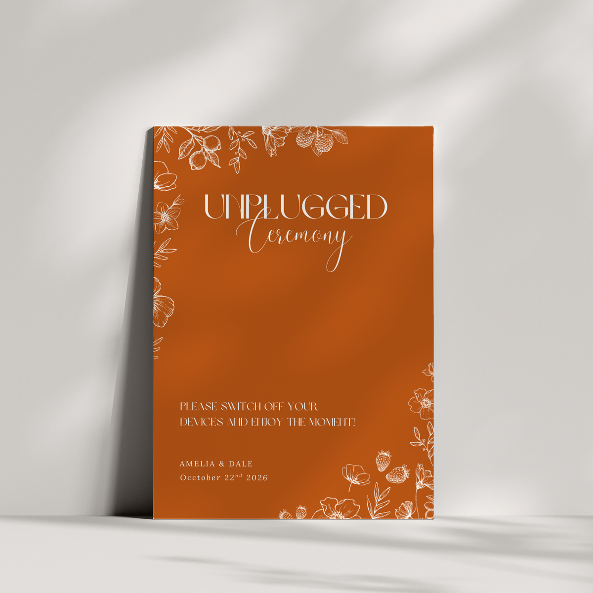 Toasted Amber unplugged ceremony wedding sign with burnt orange background and white botanical line art