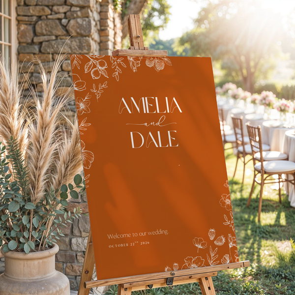 Toasted Amber wedding welcome sign with burnt orange background and white botanical line art