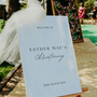 Personalised Christening Welcome Sign – A beautifully designed welcome sign featuring the baby’s name and event details, displayed on an easel at a christening venue.